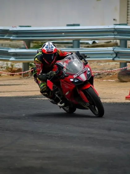 A rider on an Apache RR 310 navigates a cone drill during a personal training session.