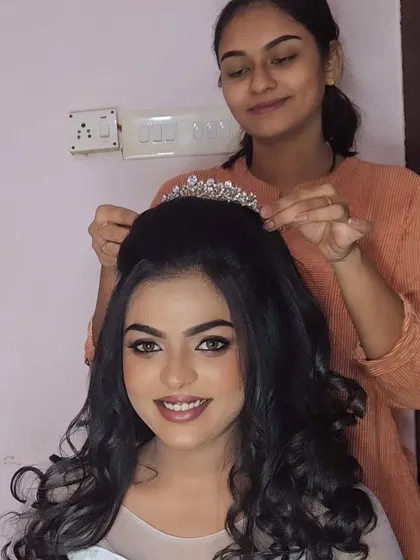 A behind-the-scenes shot of me placing the tiara on a model for a Christian wedding look. It's all about the details!