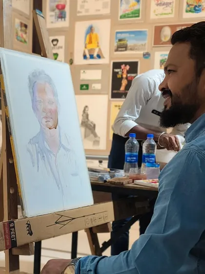 A candid moment during the demonstration, with my mentor's portrait developing on the easel.