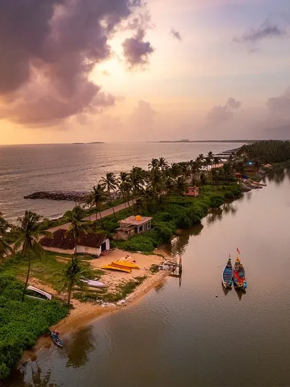 An aerial perspective captures the dramatic meeting of land and water. This thin strip of land, nestled between the serene backwaters and the vast Arabian Sea, showcases the unique coastal geography of Namma Karnataka.