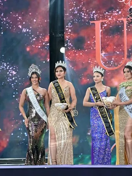 The lineup of finalists on the beauty pageant stage. This wide shot captures the scale and glamour of the event.