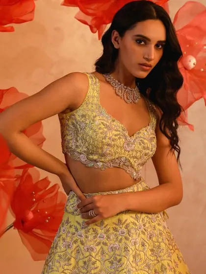 A vibrant yellow lehenga with intricate silver embroidery. This is a perfect choice for a haldi ceremony or any daytime wedding event.
