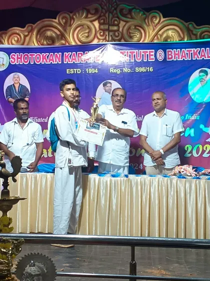 Another one of our warriors receiving his award on stage. We teach our students to accept victory with humility and to always respect the officials and their opponents.
