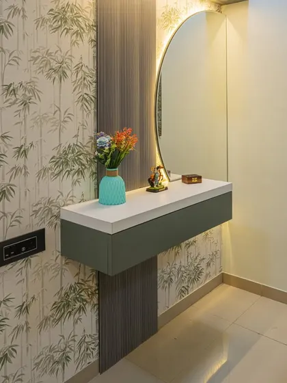 This floating dressing table with a backlit circular mirror is a great space-saving solution. The bamboo-print wallpaper in the background adds a touch of nature and tranquility.