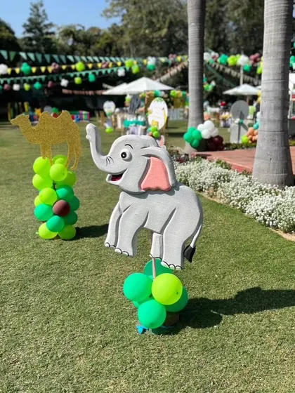 Cute elephant and camel cutouts with balloon bases, placed around the lawn to enhance the jungle theme.