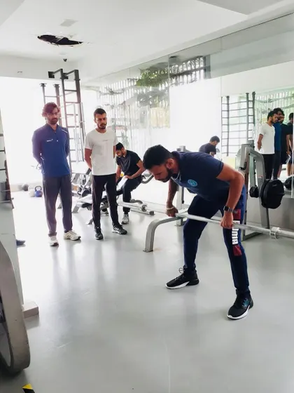 Demonstrating the correct posture for a bent-over row, emphasizing a flat back and engaged core.