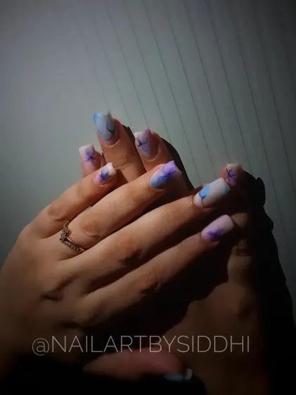 A full hand view of the abstract blossom nails, showing the dreamy, artistic effect.