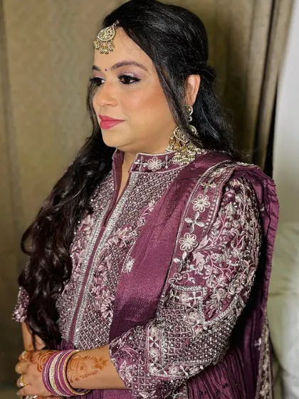 A client in a beautiful purple anarkali.