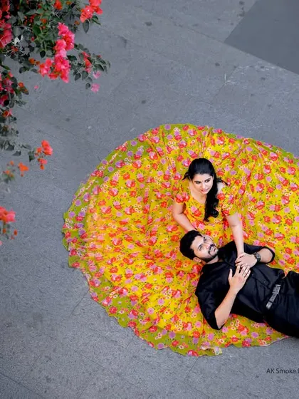 An artistic top-down shot from a Coimbatore pre-wedding session, with the bride's vibrant yellow dress spread out like a flower.