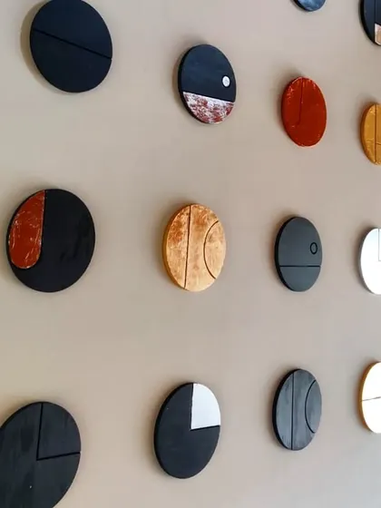We believe in adding a personal touch to our spaces. These circular wall art pieces were designed and crafted in our own studio for a client's home. Made with wood, vegetable dyes, and gold and silver leaf, they represent the phases of the moon and add a layer of bespoke artistry to the interior.
