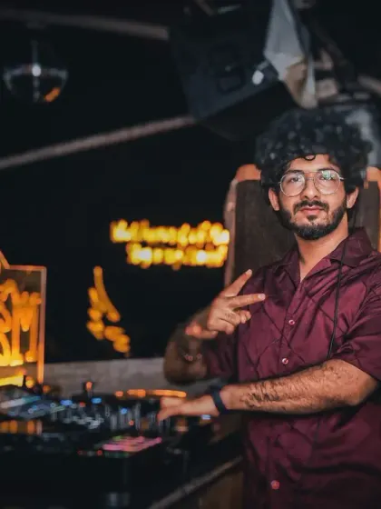 Posing for a quick photo behind the decks at Cafe Mambo. It's important to me to be approachable and connect with the audience during my sets.