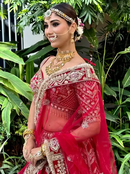 A side profile of a model with a floral bun, highlighting the intricate placement of the flowers and the sleekness of the hairstyle.