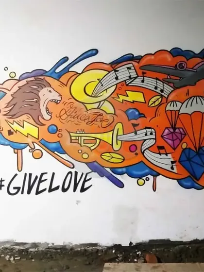 A vibrant graffiti piece created as a selfie point in Varanasi. This mural combines a roaring lion, musical notes, and the phrase "GIVE LOVE" into a dynamic and positive composition.