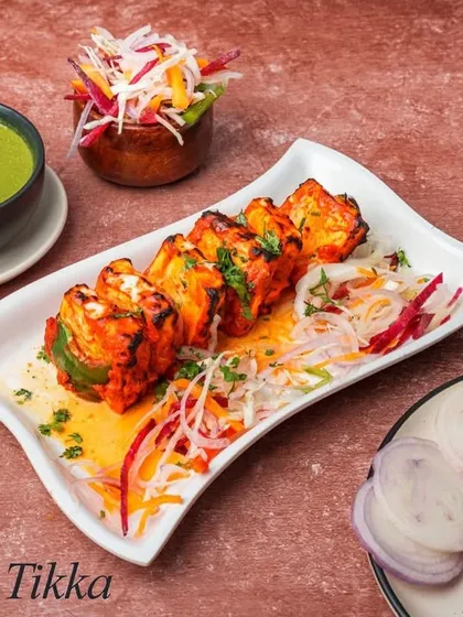 A classic vegetarian delight, our Paneer Tikka features soft cubes of paneer marinated in yogurt and spices, then grilled in the tandoor with bell peppers and onions for a smoky, charred flavor.