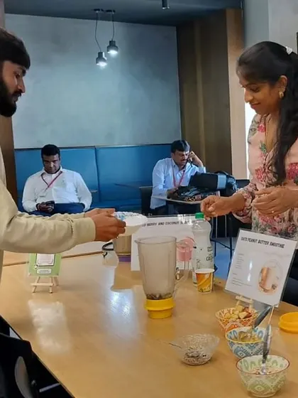 A glimpse of a hands-on smoothie-making session in action. An employee is adding ingredients to a blender, learning how to combine flavors and nutrients for a perfect breakfast or snack. This is practical knowledge they can take home.