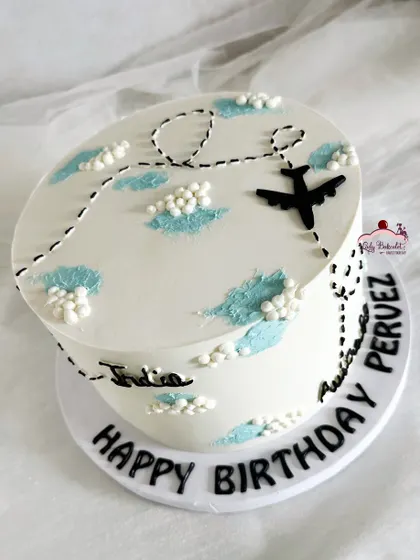 A travel-themed cake for someone moving from India to Australia, showing a plane's journey across the sky.
