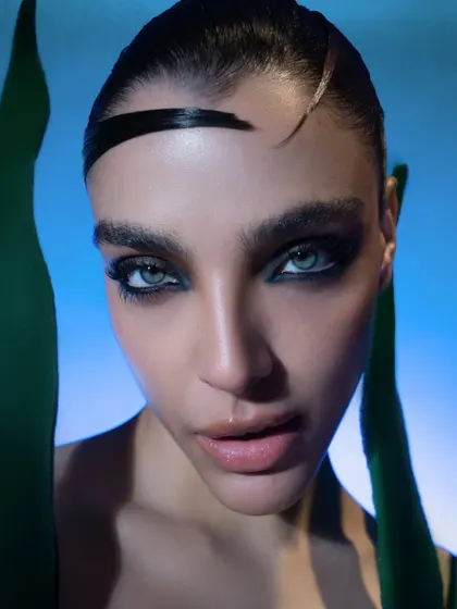 An extreme close-up focusing on the dramatic eye makeup and the model's intense expression. This is a perfect beauty shot for a model's portfolio.