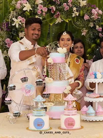 A baby shower is even more special with a full dessert table. Here we created a multi-tier cake, smaller themed cakes, cupcakes on a ferris wheel, and other treats, all coordinated for a beautiful "He or She" gender reveal party.