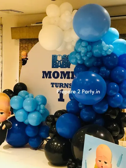 A detailed shot of the balloon arch from the "Boss Baby" party, showing the mix of dark blue, light blue, black, and white balloons.