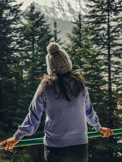 A winter scene in Manali, with snow-covered trees and a peaceful, quiet atmosphere.