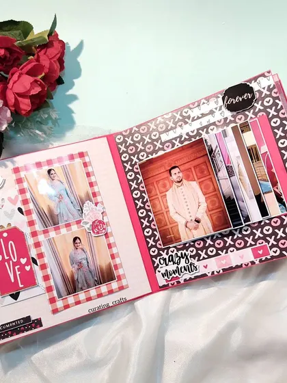 An inside page of an anniversary scrapbook, featuring a waterfall card that reveals multiple photos and plenty of space for handwritten notes.