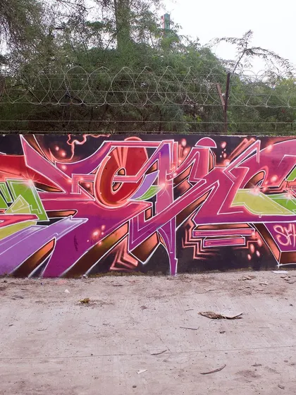 This piece features a more structured, geometric style of lettering in pink and purple. It's a different approach to wildstyle, focusing on clean lines and angles.