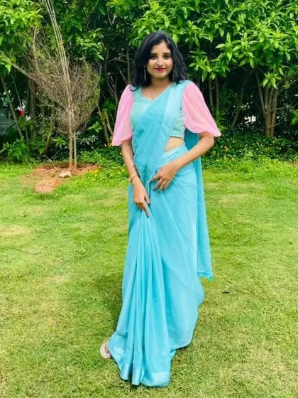 For a more contemporary look, this client chose a simple sky-blue saree. I designed a contrasting blouse with sheer pink puff sleeves for a modern and stylish touch.