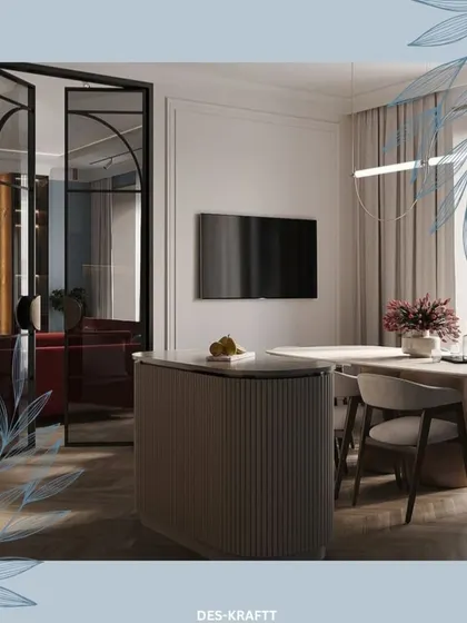A fluted kitchen island is paired with a sleek dining table, separated from an adjacent room by a modern, black-framed glass partition that adds an industrial-chic touch.