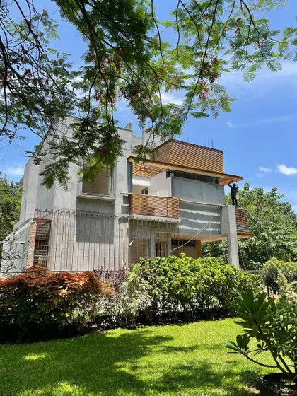 The house nestled amongst the trees of the adjacent park.
