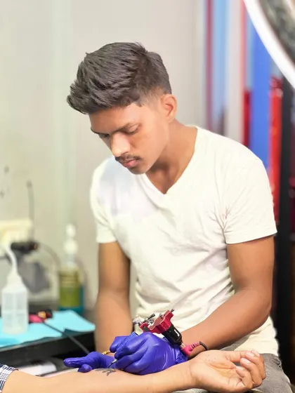 Artist Pravin focused on his craft. His steady hand and attention to detail are what make our tattoos stand out.