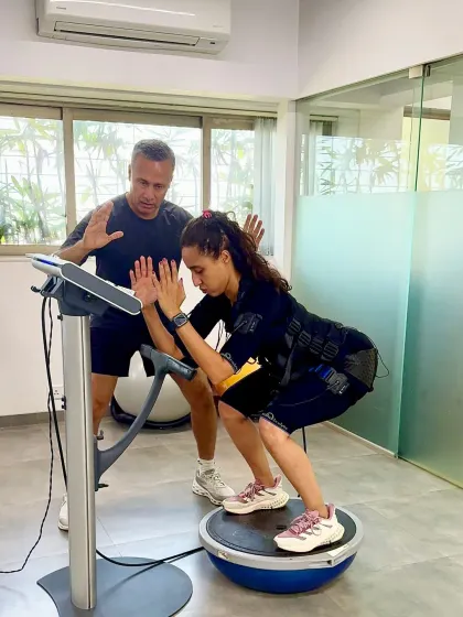 Namrata uses a BOSU ball to challenge her stability while I provide guidance. This is an example of advanced, multi disciplinary training.