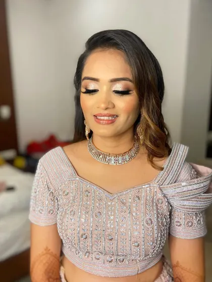 The eyes-closed shot shows the full extent of the silver glitter, creating a dazzling effect.