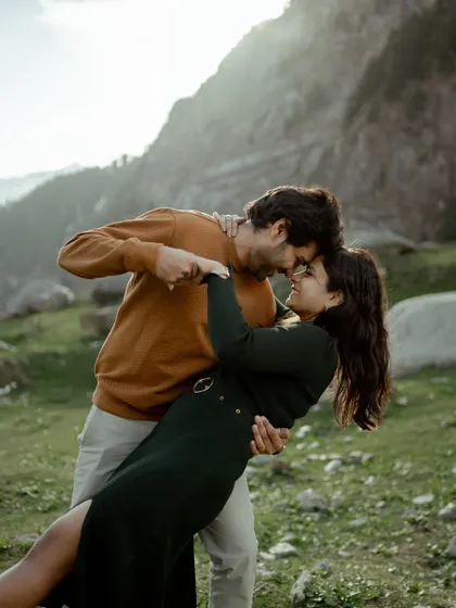 A romantic dip with the golden light of the mountains behind them. This is a perfect example of the cinematic and passionate moments we aim to create.