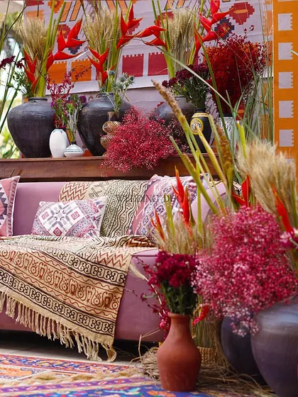 A closer look at the layered textures and colors of our African tribal decor. The mix of printed textiles, terracotta, and wild florals creates a soulful and vibrant design.