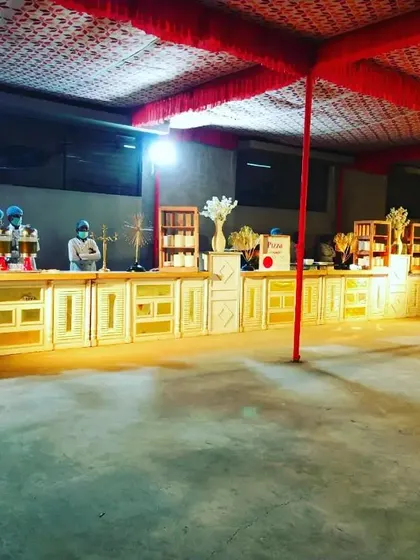 A wider view of the elegant white and gold counter, showing its full length and how it commands presence in a large venue.
