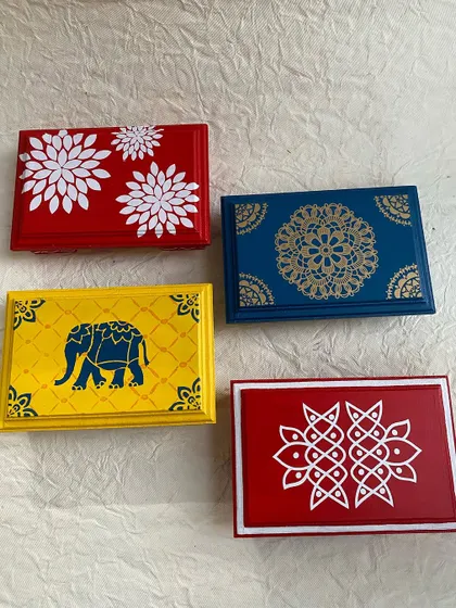 A collection of four different pooja chowki designs, including floral, elephant, mandala, and kolam patterns.