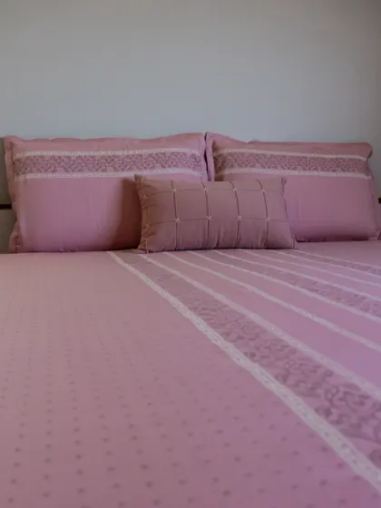 Our blush pink bedding set, crafted from soft cotton with delicate embroidered details. The subtle patterns and gentle color create a serene and romantic atmosphere, perfect for a peaceful night's rest.