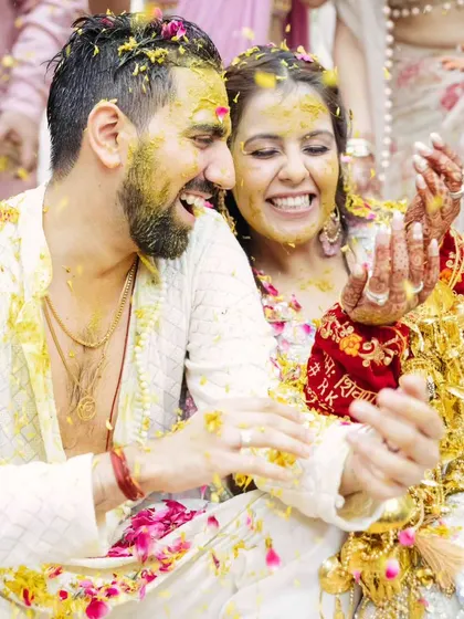 Pure joy and celebration. The couple is showered with flower petals, and their happiness is infectious.