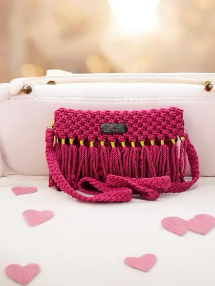 A cute pink sling bag with fringe, perfect for a fun day out. This piece was part of a party-themed photoshoot!