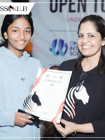 A smiling winner receives her certificate and trophy. We take pride in recognizing the achievements of female players in the competitive chess circuit.