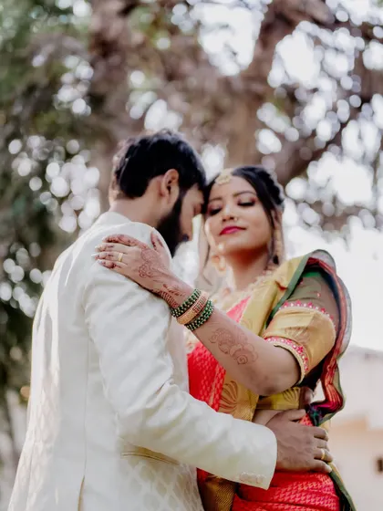An embrace that says everything. I framed this shot to highlight the bride's beautiful saree and the couple's closeness, with the soft, natural background adding to the romantic feel.