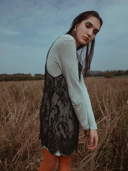 A full-body shot from 'UTOPIA', showing the layered slip dress over a long-sleeved top.