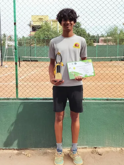 A solo shot of Svar with his doubles finalist trophy from the NS U-14 Coimbatore tournament. This experience is a valuable part of his development as a competitive player.