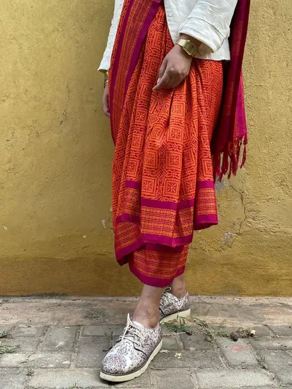 We believe in giving beautiful textiles a second life. This image showcases our overprinting service, where we take a pre-loved vintage Kanjeevaram silk saree from our founder's personal collection and refresh it with a vintage 'chunadi' block print.