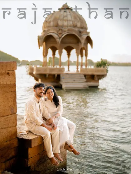 A candid moment of laughter and connection as the couple sits by the water in Rajasthan. This shot captures their relaxed and happy bond during their destination pre-wedding shoot.