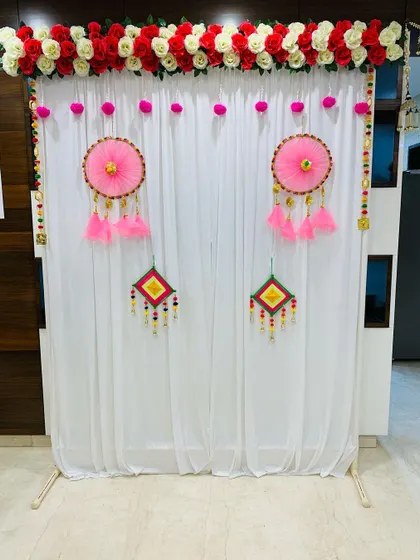 My services also cover traditional and religious functions. For this Updhyan ceremony, I created a clean and elegant backdrop using a white curtain, a floral border of red and white roses, and handmade decorative hangings.