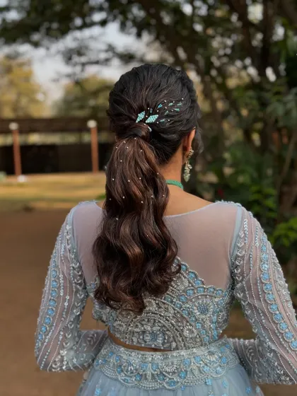 Another angle of the stylish ponytail, highlighting the beautiful waves and the artful placement of the accessories.