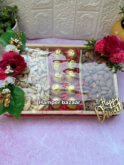 A beautiful and budget-friendly Diwali hamper featuring a pine wood tray filled with dry fruits and chocolates. It's a classic and thoughtful gift for friends, family, and corporate connections.