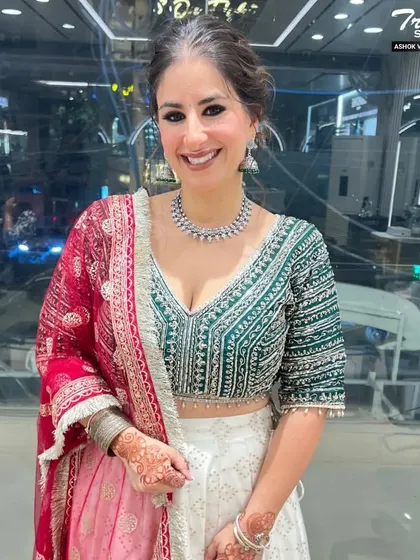 This client looks radiant and ready for a wedding celebration. Her makeup is fresh and luminous, with defined eyes and a natural lip color that enhances her beautiful smile.