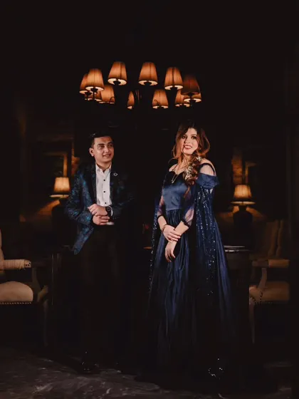 My personal favorite, the navy blue infinity gown. It features a detachable sequin trail and delicate feather details on the sleeves for a touch of glamour.